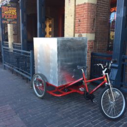 Carry cargo with pedal powered vehicle. Vehicles made by Main Street Mobility